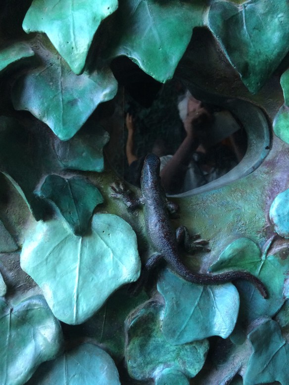 This little lizard is one of many creatures peering out from the bronze leaves that completely cover the main door