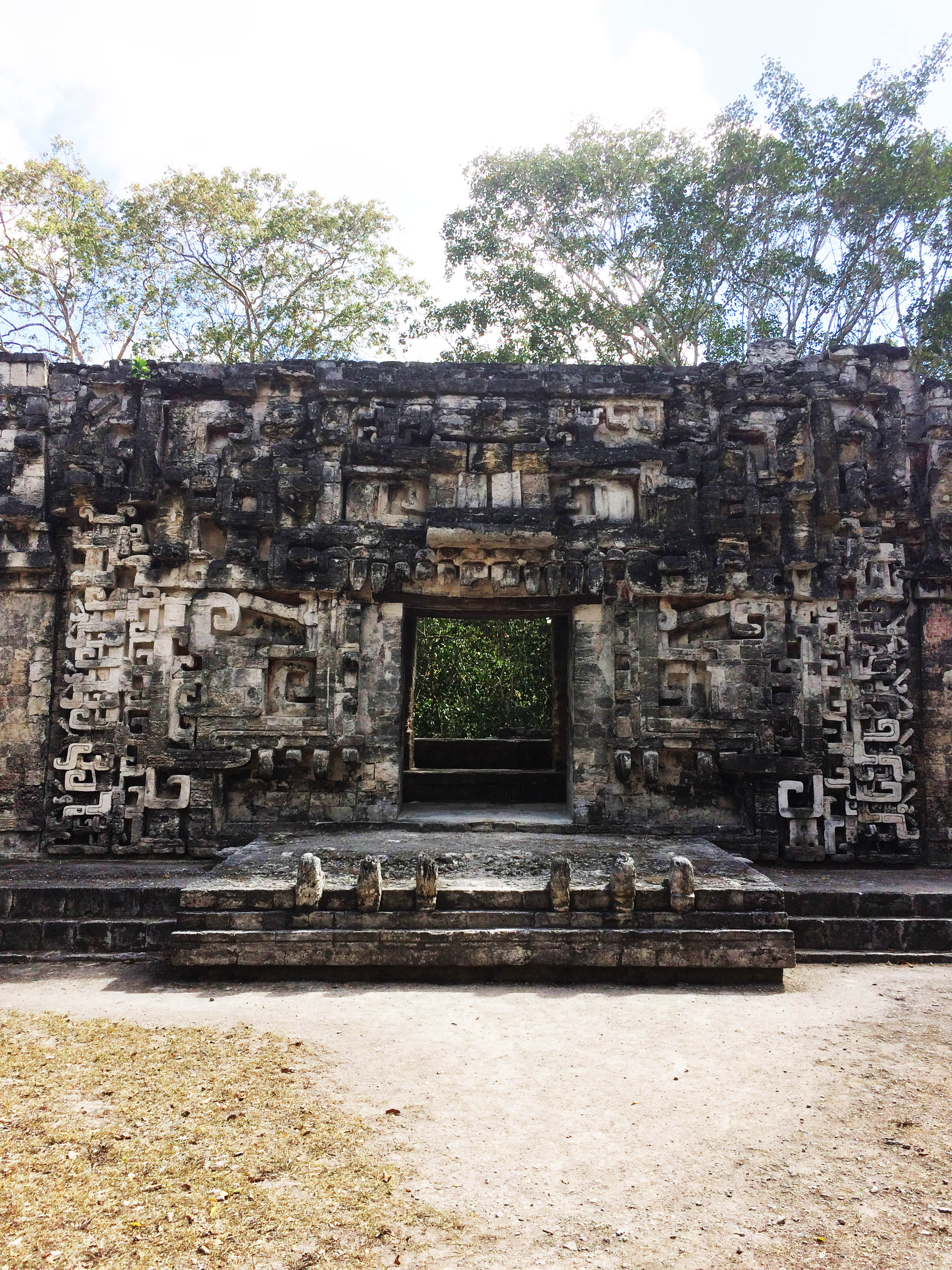 The entrance to the Jaguar Palace. The stones sticking up in front are its teetch, and you can see stylized eyes and ears to either side of the doorway.