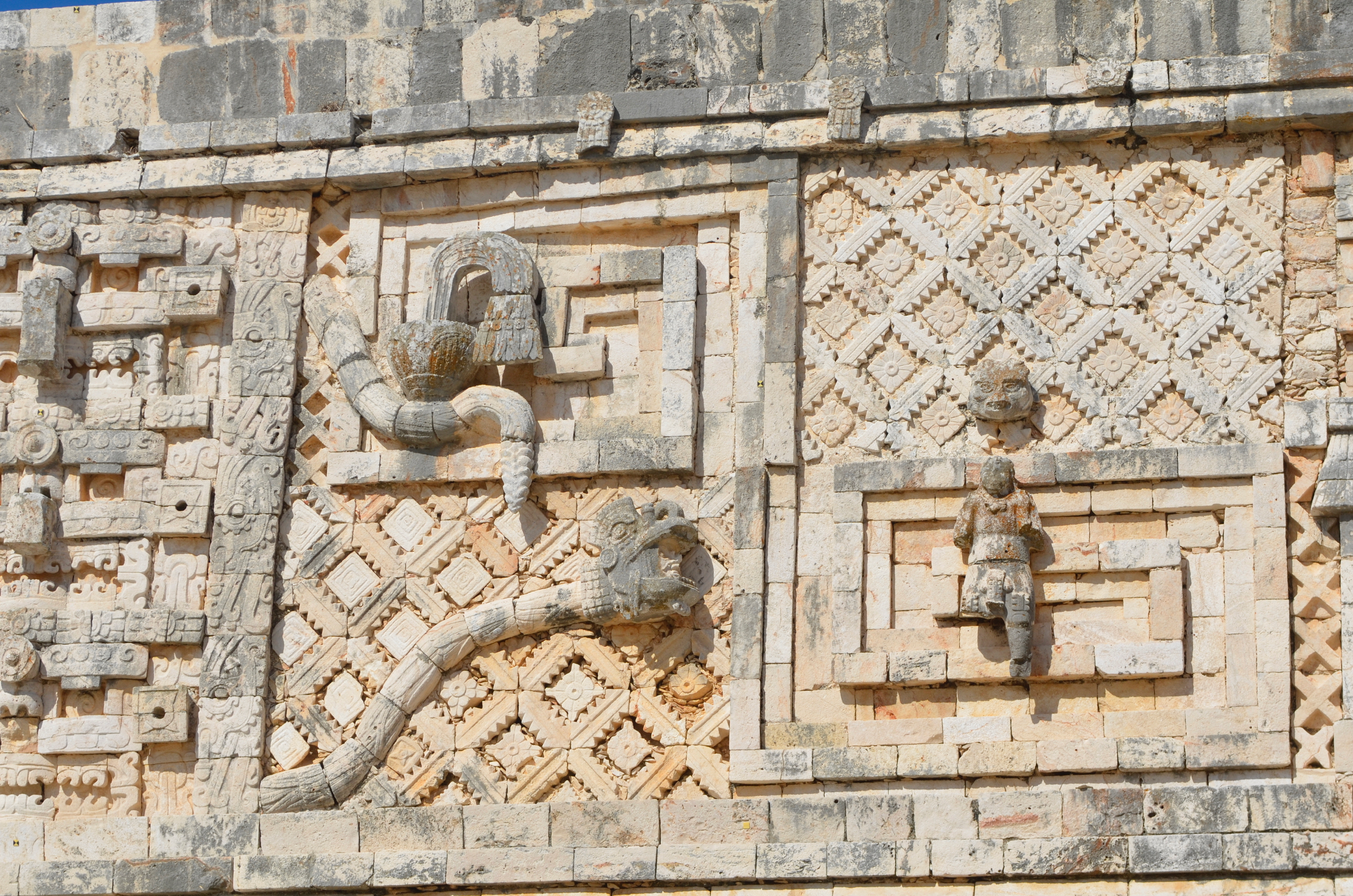The buildings at Uxmal are decorated with gorgeous bas-relief sculptures. You can see a plumed snake here, with a head emerging from its open mouth. This is the "spirit snake" incarnation of Kulkulcan, enabling the spirit of an ancestor to communicate with the living.